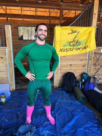 Mark in a green bodysuit and pink boots