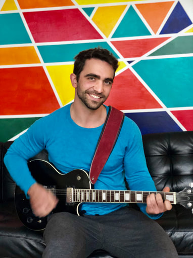 Mark playing an electric guitar